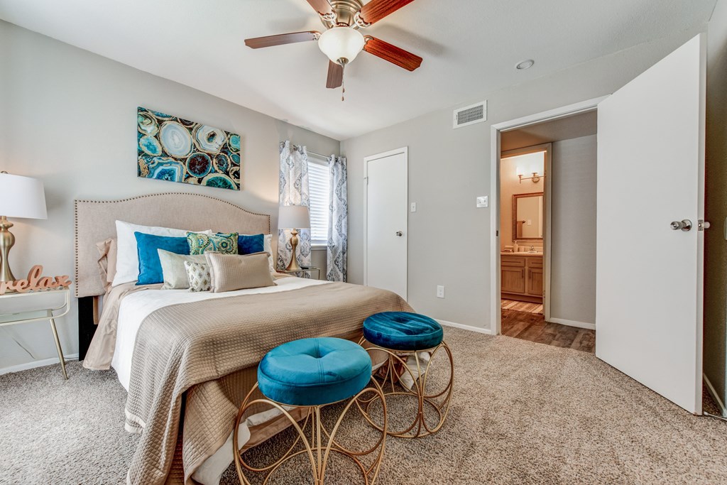 a bedroom with a bed and a ceiling fan