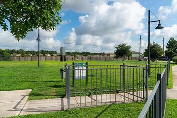 a park with a fence and a grass field