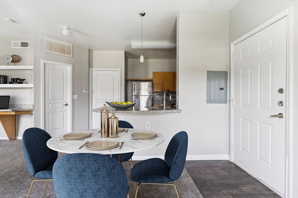 a dining room with a table and chairs and a kitchen