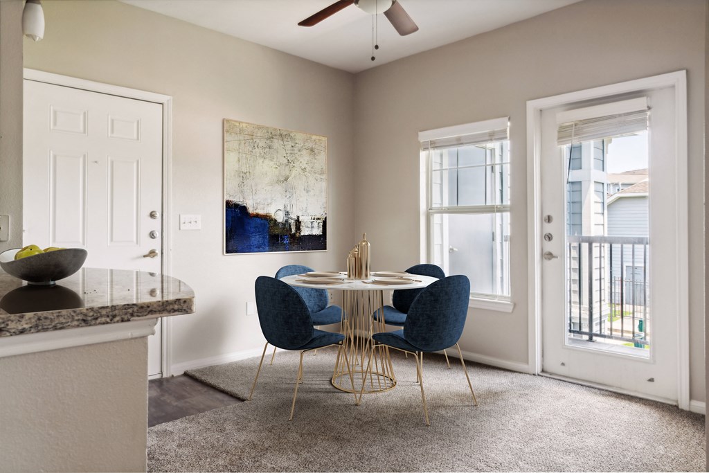 a dining room with a round table and blue chairs