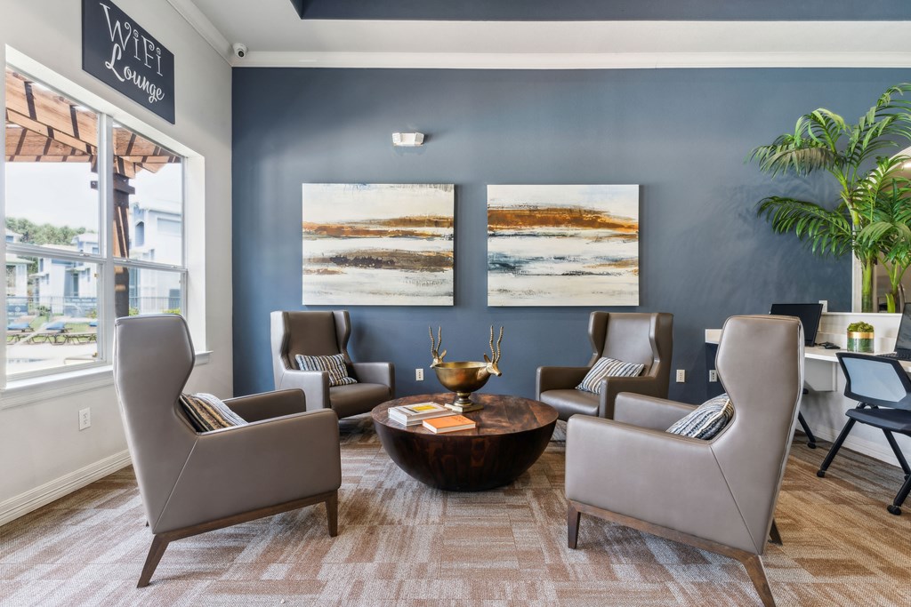 a living room with blue walls and chairs and a table