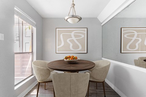 Dining nook with round table and upholstered chairs at 2151 Kirkwood Apartments, Houston, TX