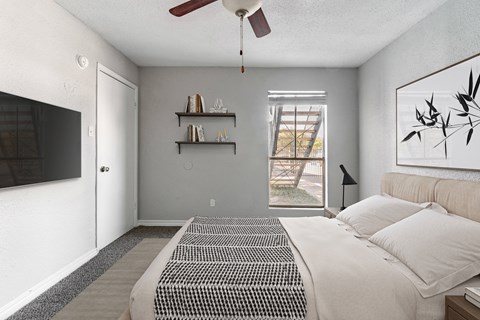 Modern bedroom with wall mounted television at 2151 Kirkwood Apartments, Houston, Texas