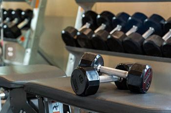 a pair of dumbbells sitting on a table in a gym
