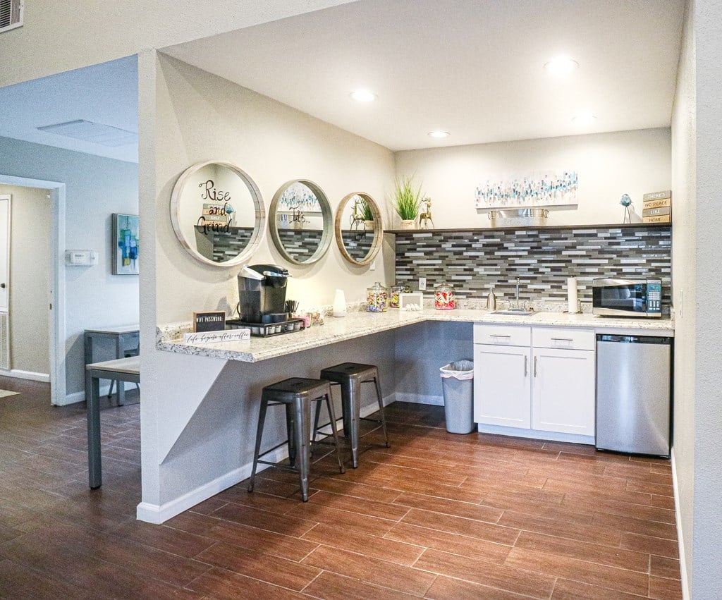 a kitchen with a counter and stools