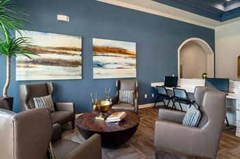 a living room with blue walls and chairs and a table