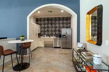 a kitchen with a stainless steel refrigerator and a table