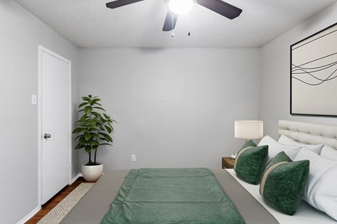 Bedroom with green bedding and ceiling fan at Creek on Calloway Apartments, Richland Hills, 76118