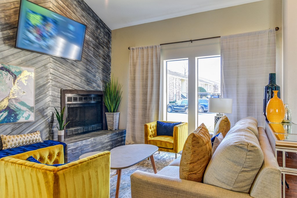 a living room with couches and chairs and a fireplace