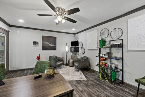 a living room with a ceiling fan and a table
