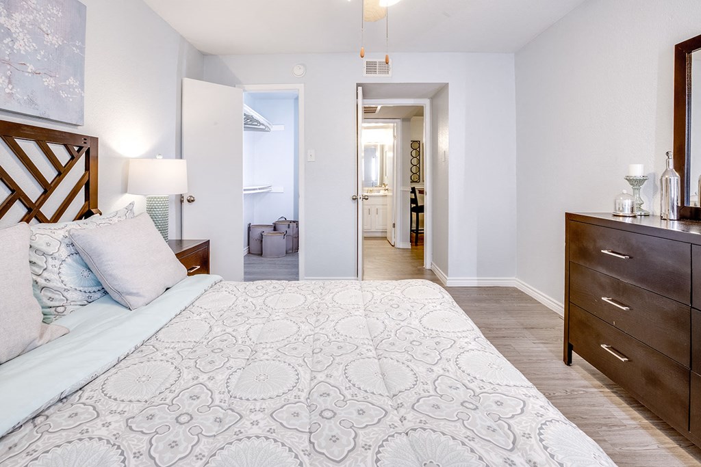 A bedroom with a large bed and a wooden headboard.