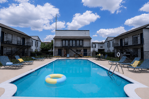 A swimming pool with a yellow and blue float in the middle.