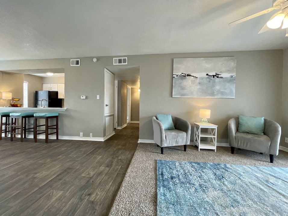 a living room with a couch and a chair  at The Alara, Houston, 77060