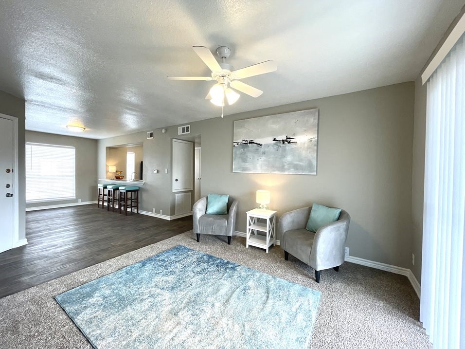 a living room with two couches and a rug  at The Alara, Houston, TX