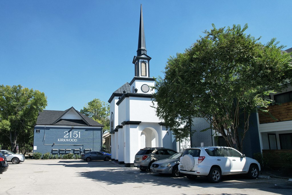 a white church with a tall steeple and a clock tower  at 2151 Kirkwood, Houston, Texas