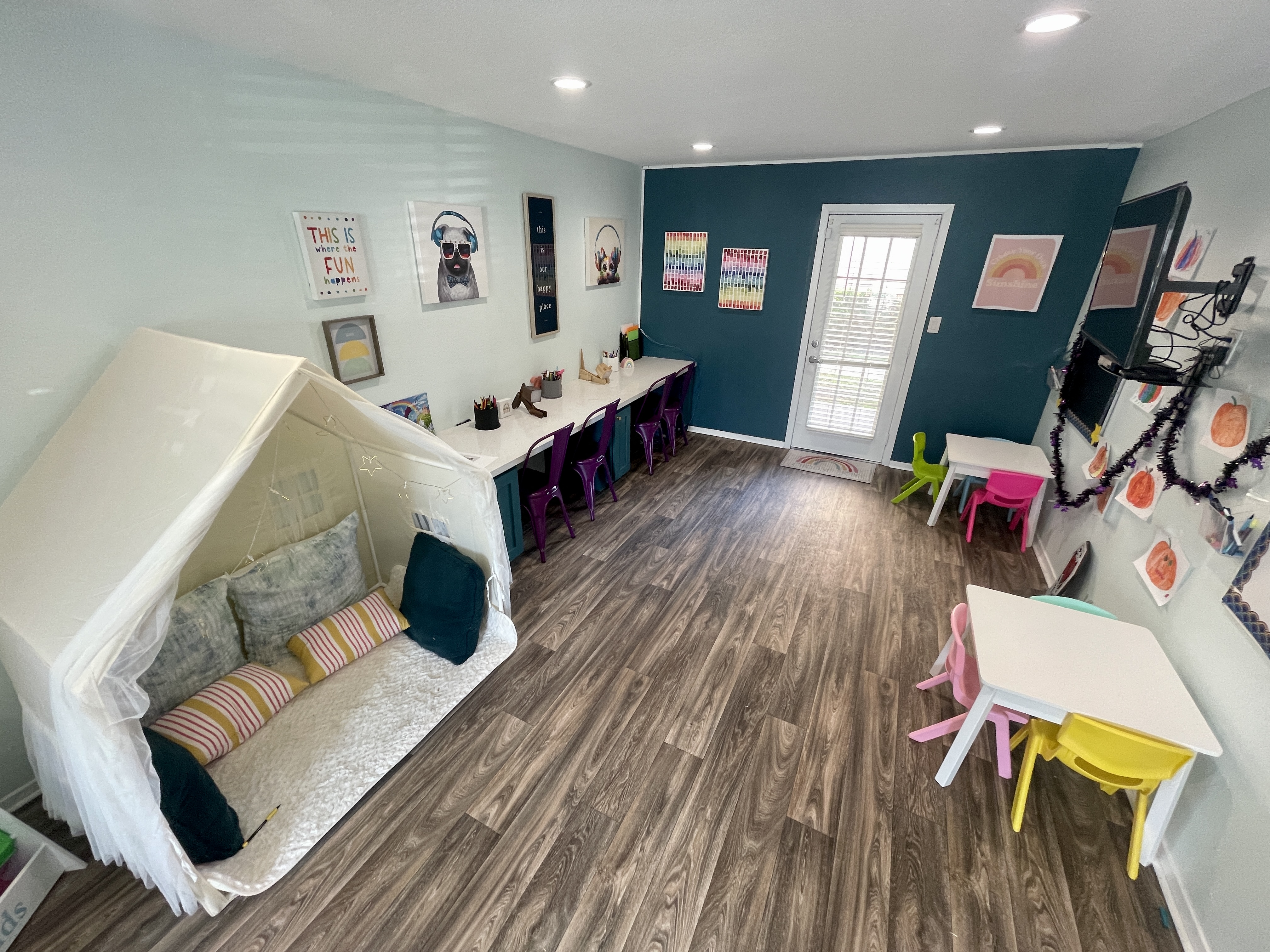 a room with a slide and a table and chairs  at The Alara, Houston, TX