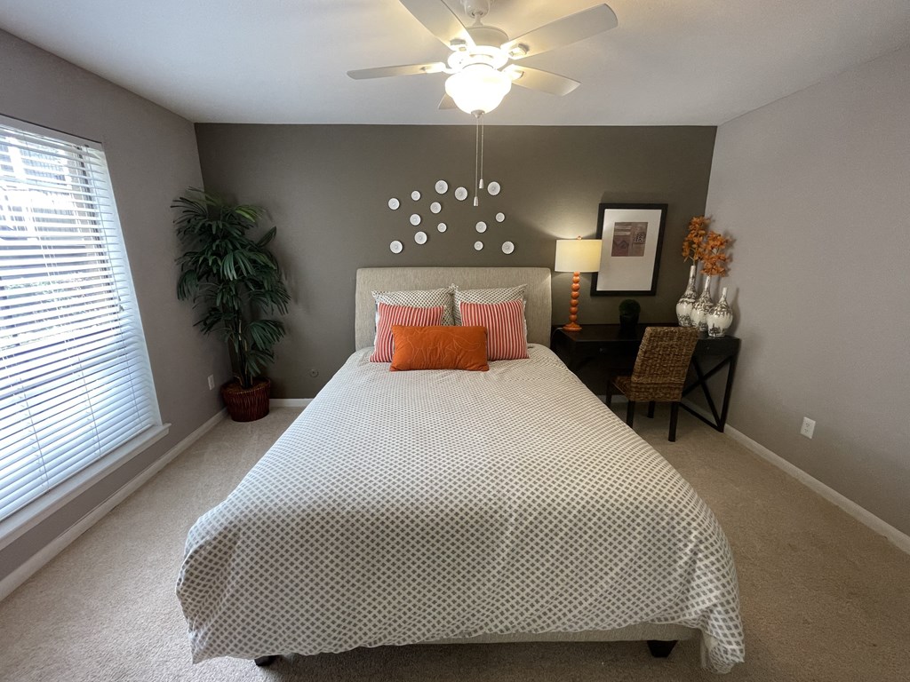 a bedroom with a large bed and a ceiling fan at Oaks of Westchase, Houston, 77042