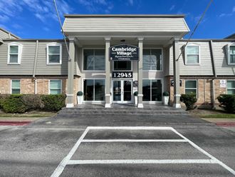 an office building with a parking lot in front of it