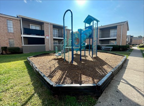 Children playground with blue slide and climbing equipment at The Alara Apartments, Houston