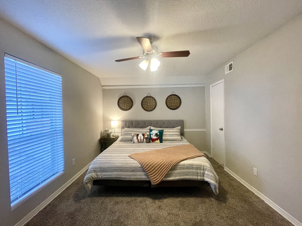a bedroom with a large window and a ceiling fan  at 2151 Kirkwood, Houston, TX