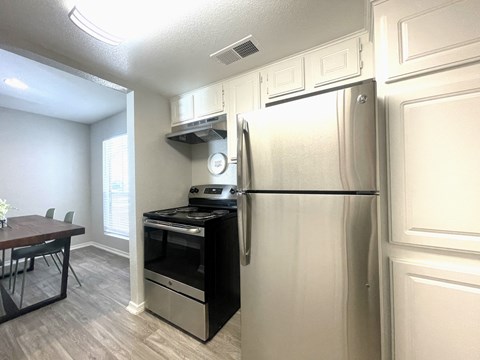a kitchen with stainless steel appliances and a refrigerator