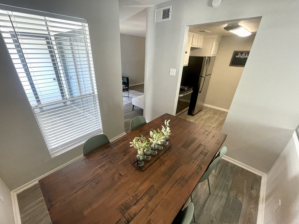 a dining room with a wooden table and green chairs  at 2151 Kirkwood, Houston, Texas