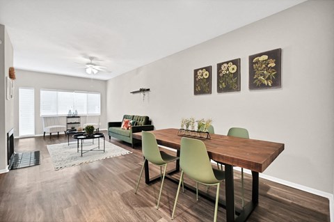 Open dining room with green chairs and wood table at Augusta Court Apartments, Houston, 77057