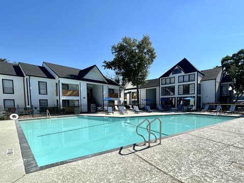 Swimming pool with surrounding residential buildings at 2151 Kirkwood Apartments, Houston, Texas