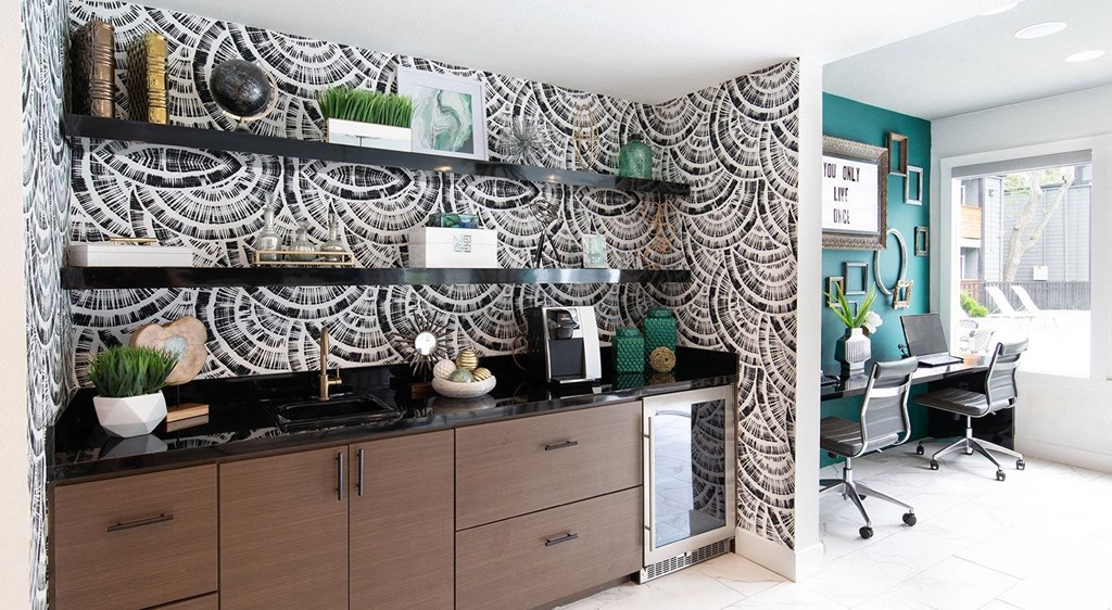 a home office with a desk and a black and white wall