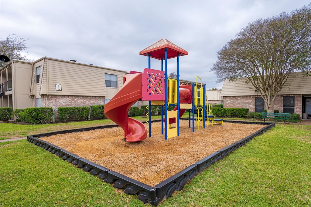 a playground in a yard with a slide