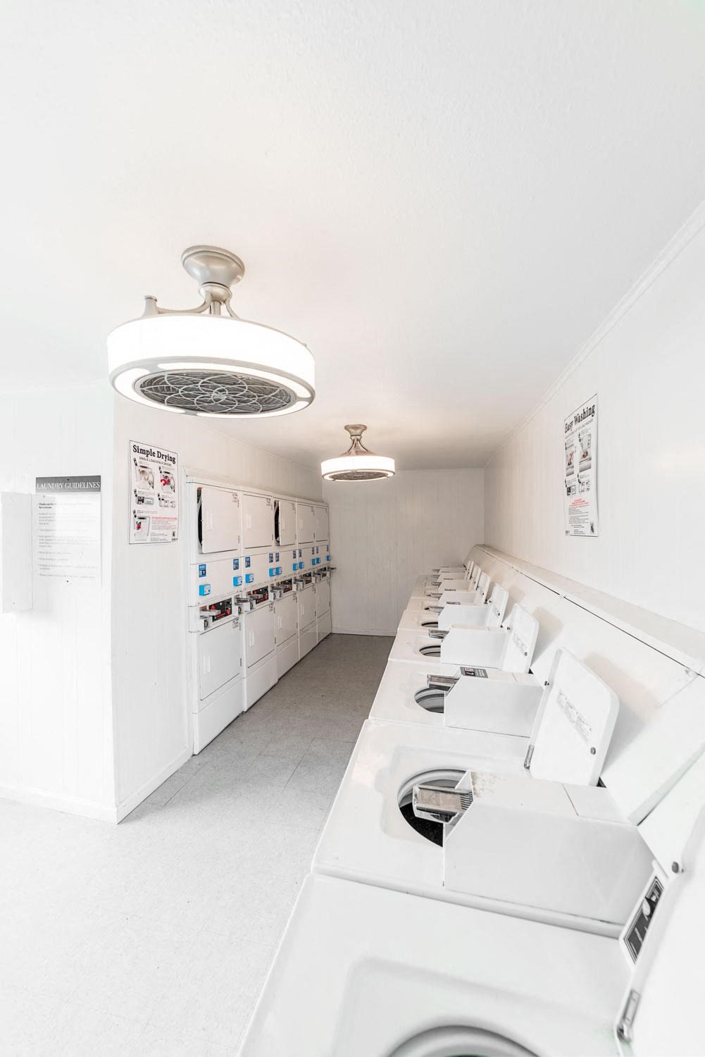 a laundry room with white appliances and sinks
