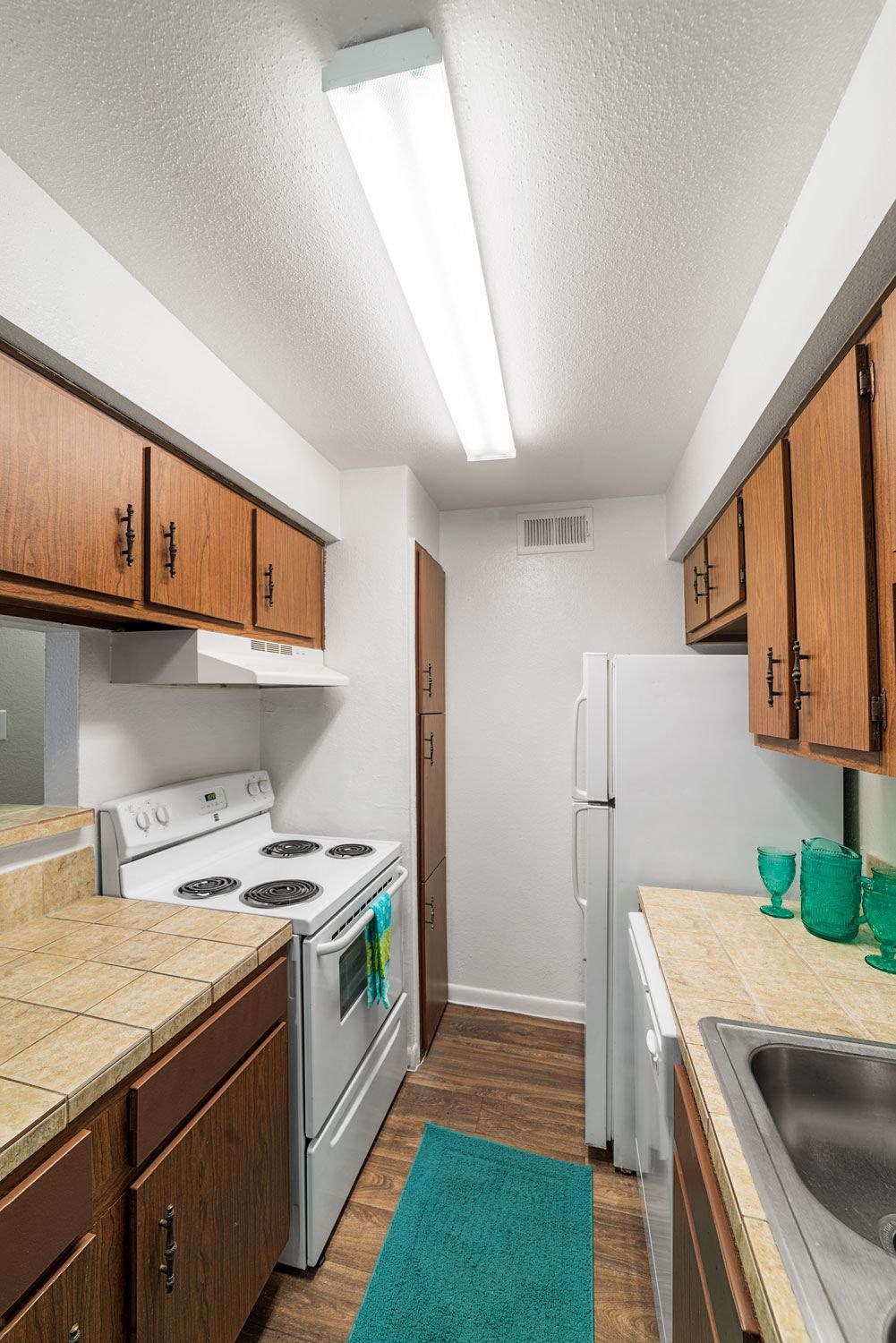 a kitchen with white appliances and wooden cabinets