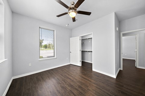 Empty bedroom with hardwood floors and window at The Aurea Apartments, Texas