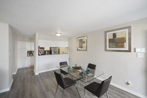 A dining room with a glass table and chairs.