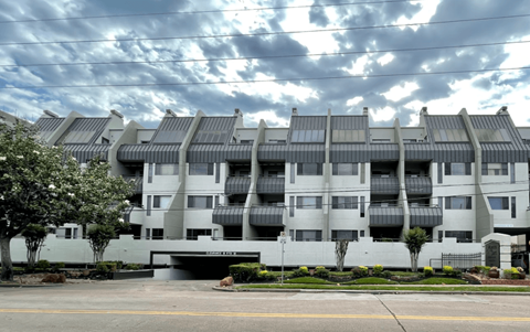 Modern apartment building with metal roofing and balconies at Augusta Court Apartments, Houston, TX 77057