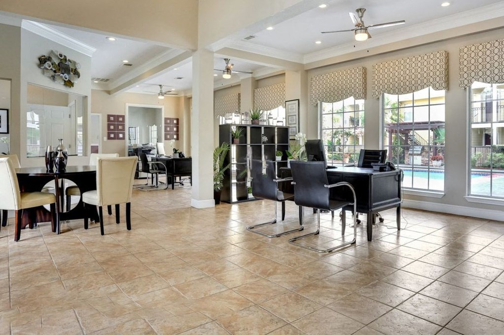 A spacious room with a dining table and chairs.