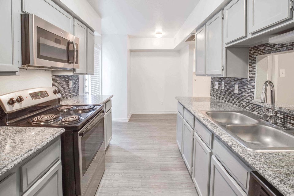A kitchen with a stove top oven and a microwave.