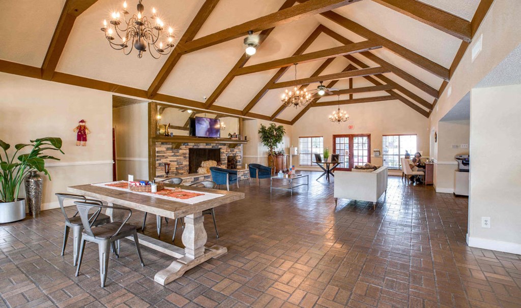 A large open living room with a dining table and chairs.