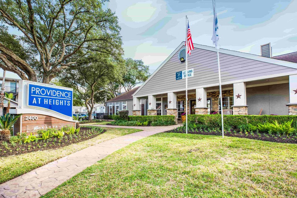 A sign for Providence at Heights is in front of a building.