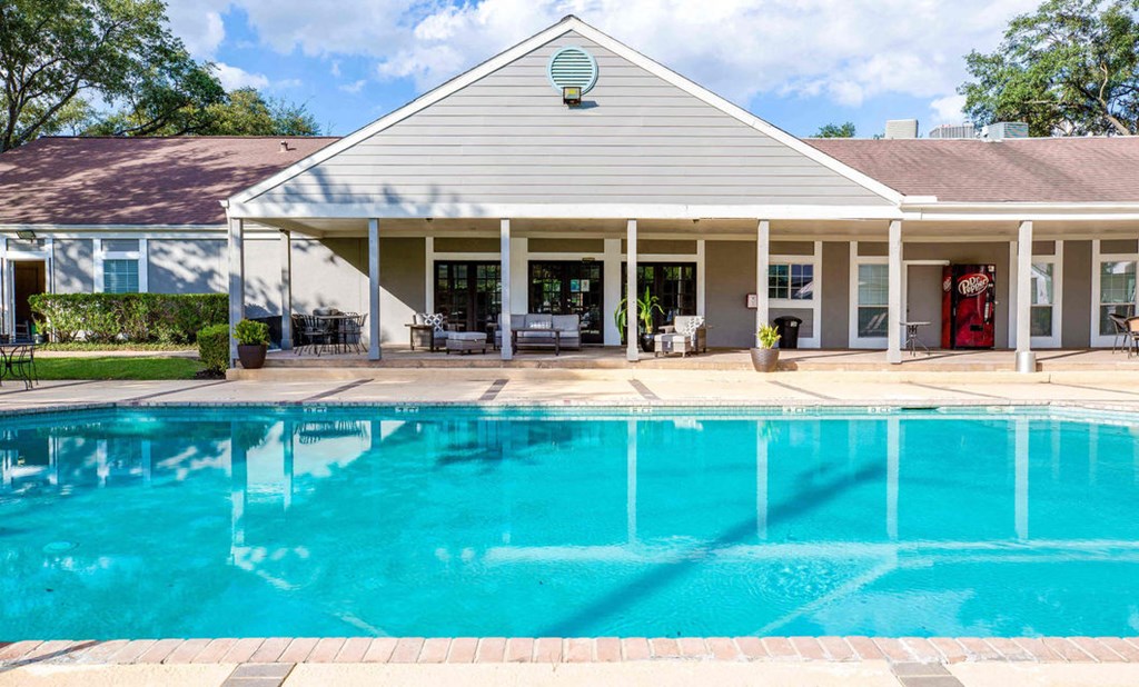 A house with a pool in front.