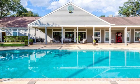 A house with a pool in front.