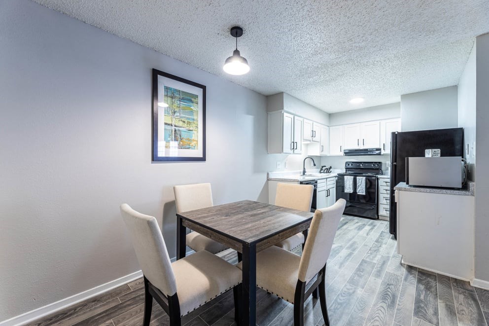A dining room with a table and chairs.