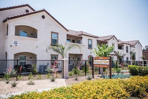 A sign that says Grand Villas in front of a building.