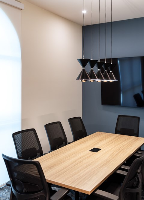 A conference room with a long table and chairs.