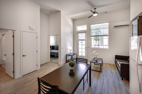 A modern dining room with a wooden table and chairs.