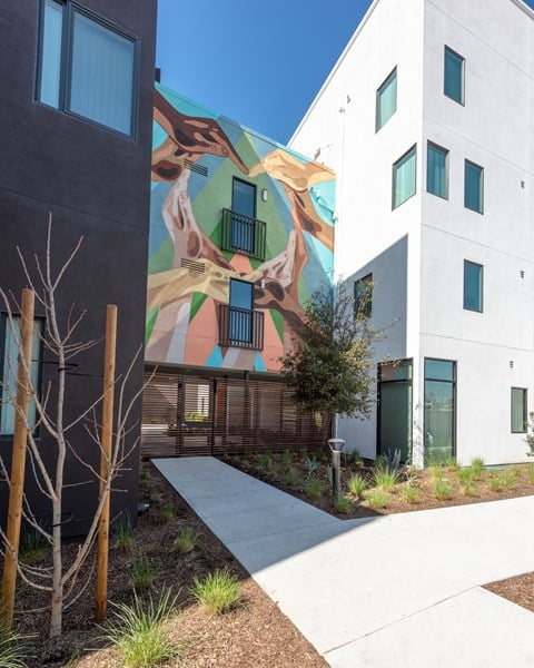 A modern building with a mural on the side.