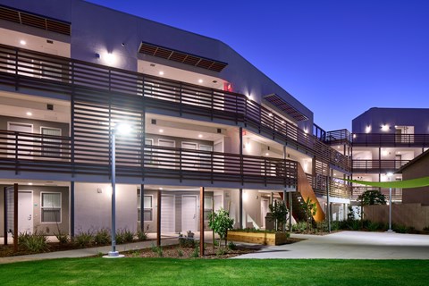 A modern building with a green lawn in front.