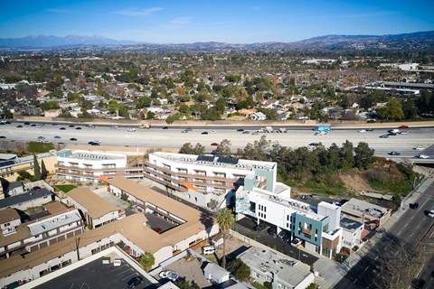 A view of a city from above with buildings, roads, and cars.