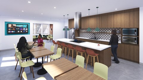 A woman is sitting at a table in a modern kitchen.