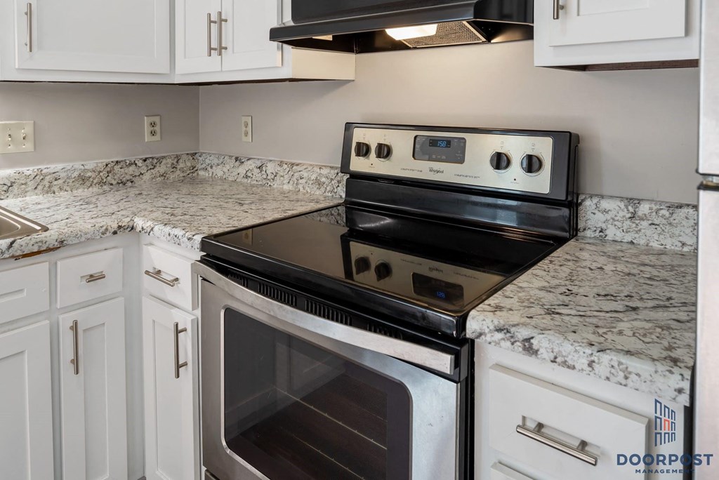 a kitchen with granite counter tops and a stove